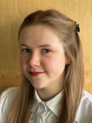 A portrait of Amy Henderson wearing a white shirt