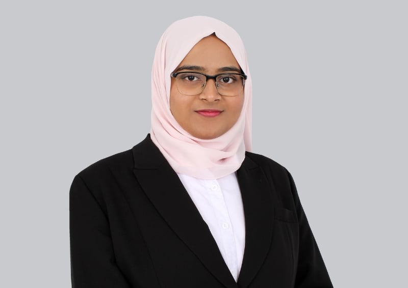 A photo of Afeefa Muhammad Iliyas against a grey background.