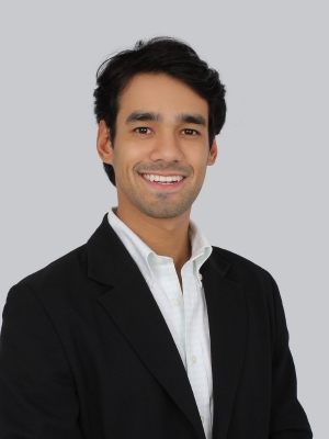 A portrait of Jesús David De Oliveira against a grey background