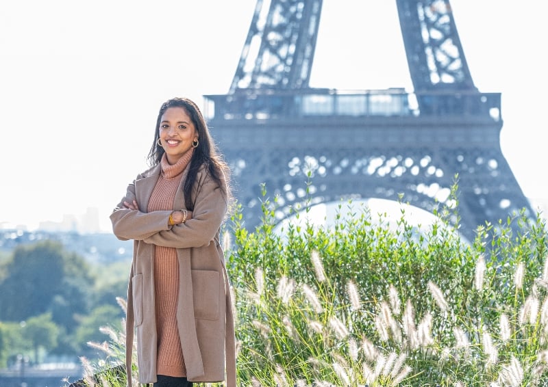 Jananie standing in front of an exemplar of material economy: the Eiffel Tower in Paris! Image credit: Jananie Balapitathees